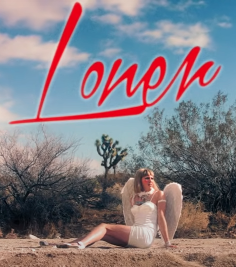 The thumbnail for 'Loner' a music video for the band 'Dehd'. It features a woman in a short dress and angel wings looking off into the distance while seated on a desert road